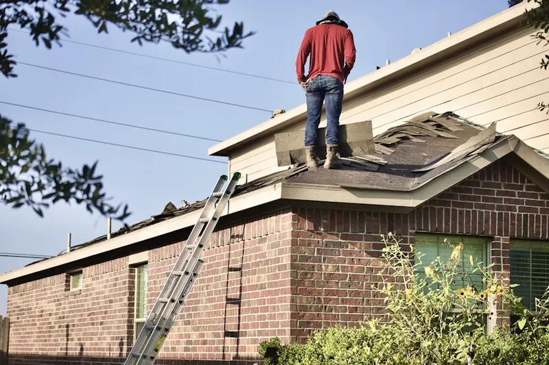 Professional roofer working on a residential roof in Grant